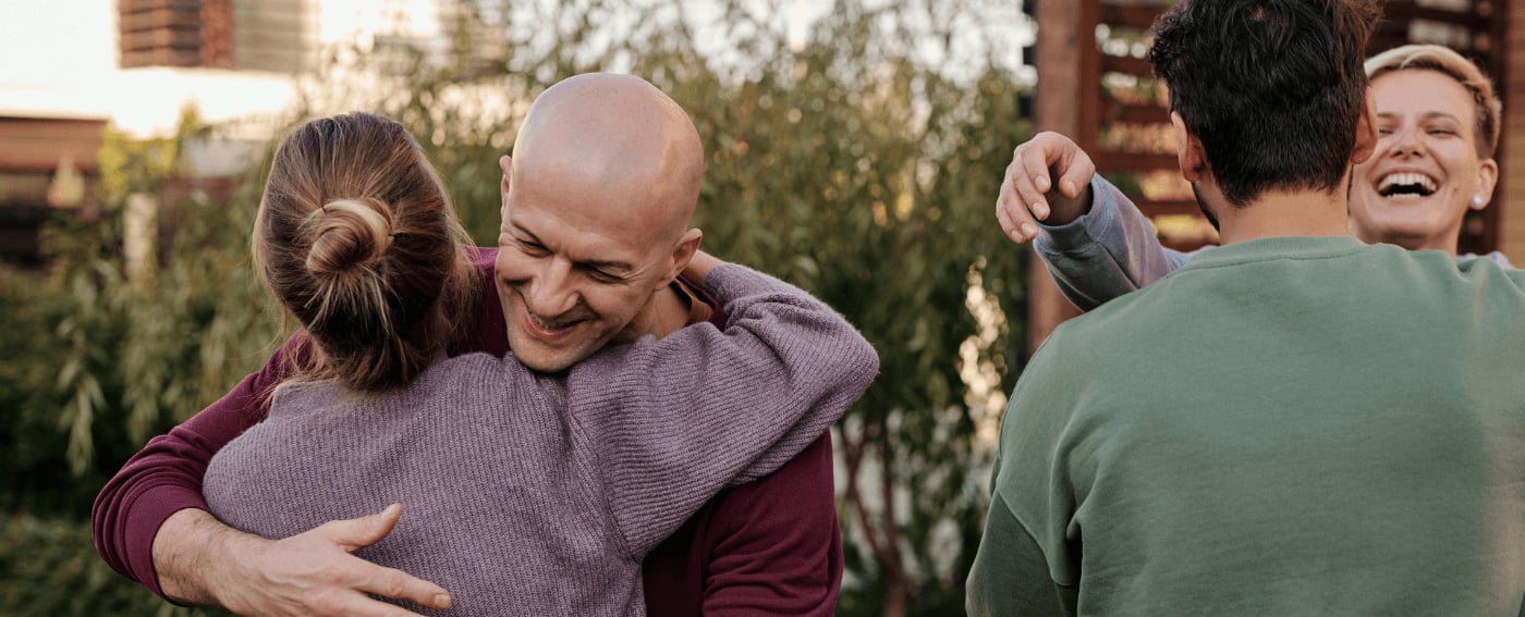 Members of a church community greeting and hugging each other.